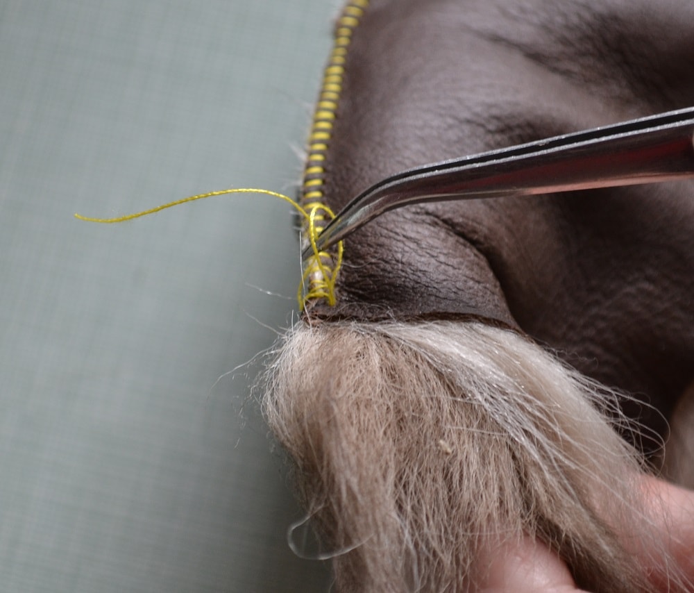 Take tweezers and catch thread end