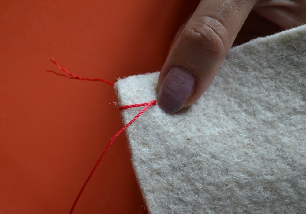 Making a first loop around fabric edge