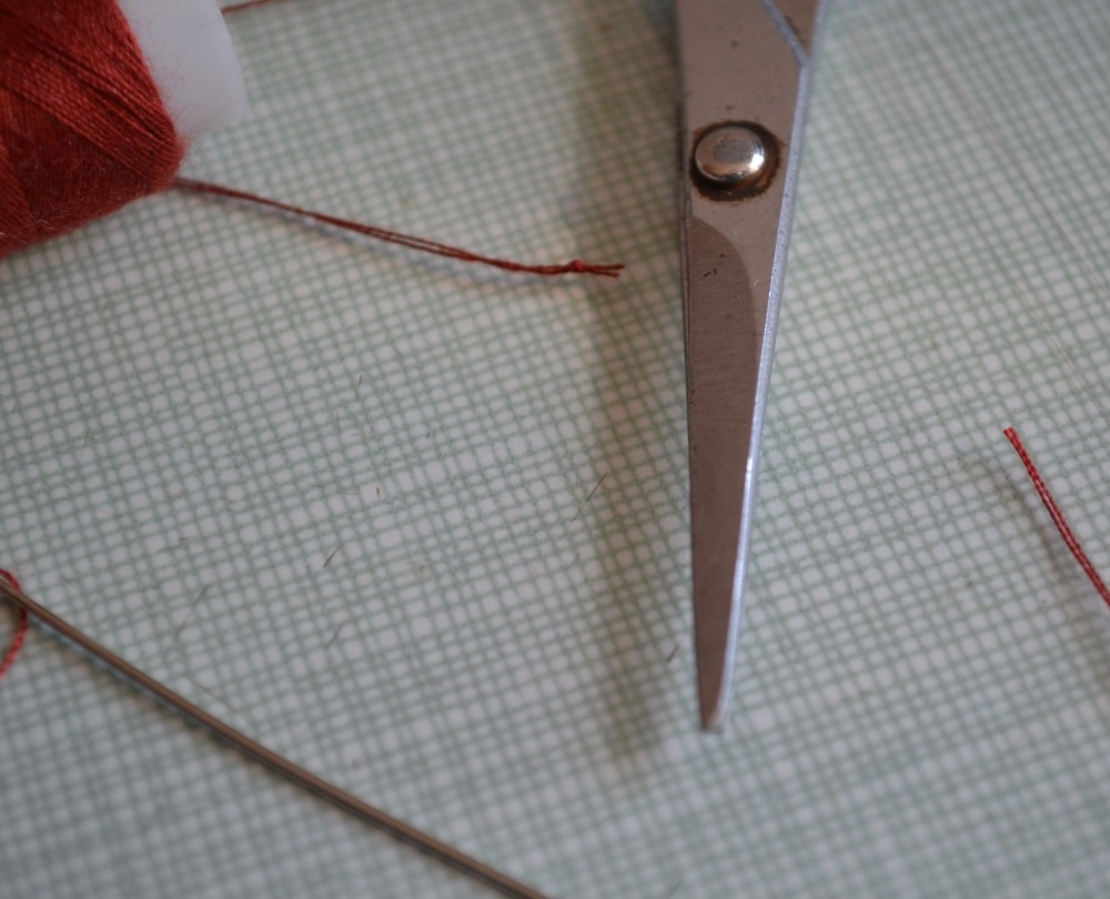 Trim the thread ends near the knot