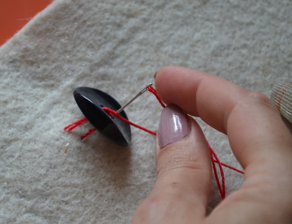 Between the button and fabric can insert a match