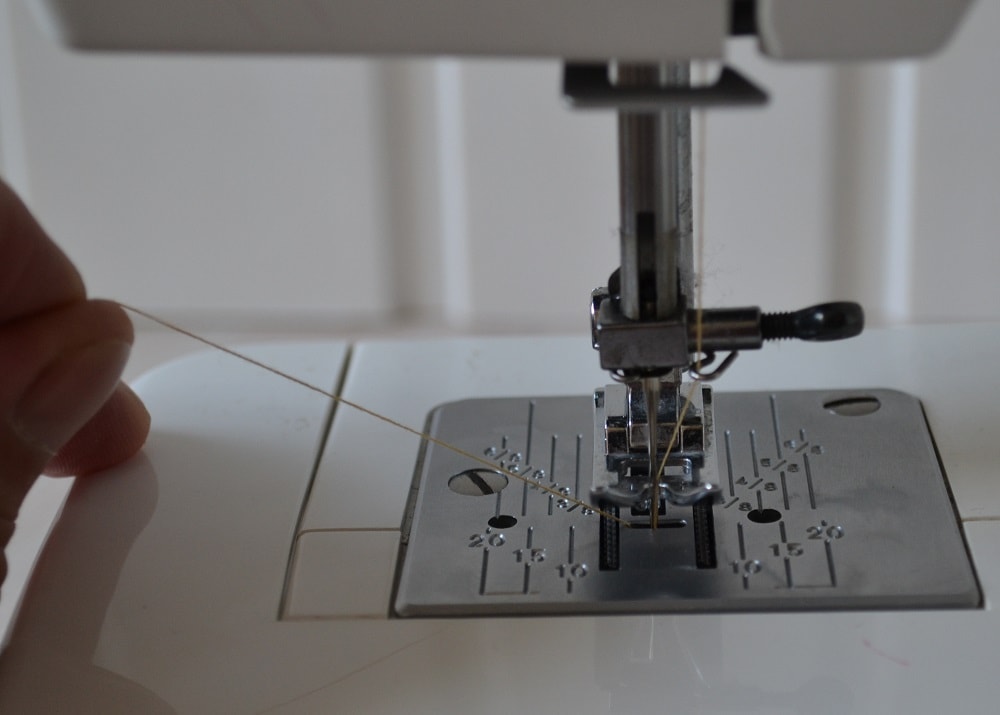 Pull the bottom thread through hole of needle plate