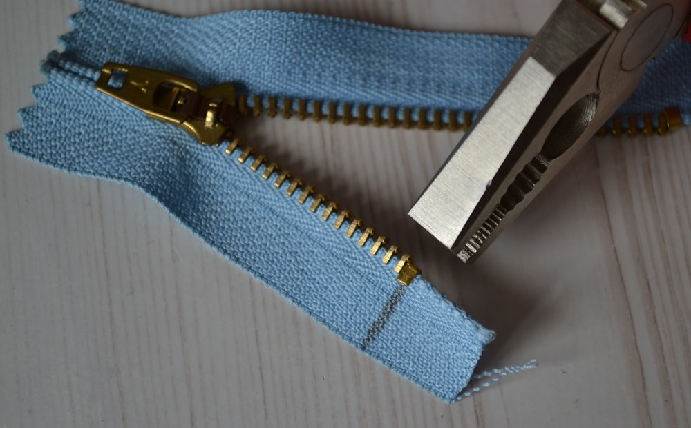Put stops back onto zipper strips