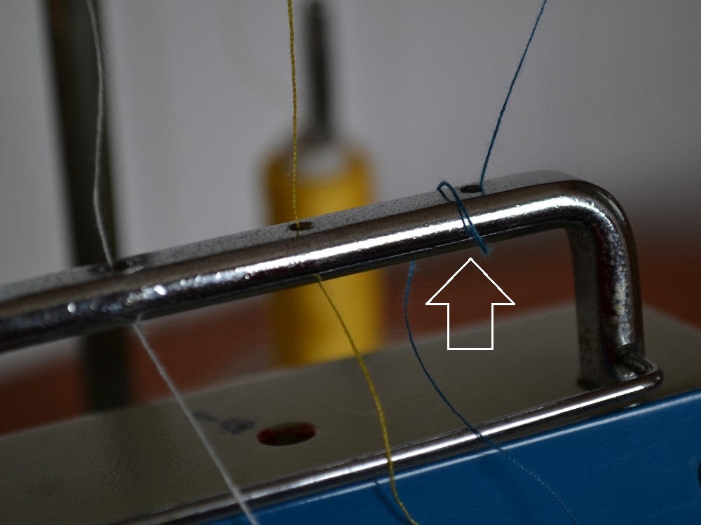 Holes on top threads guide bar