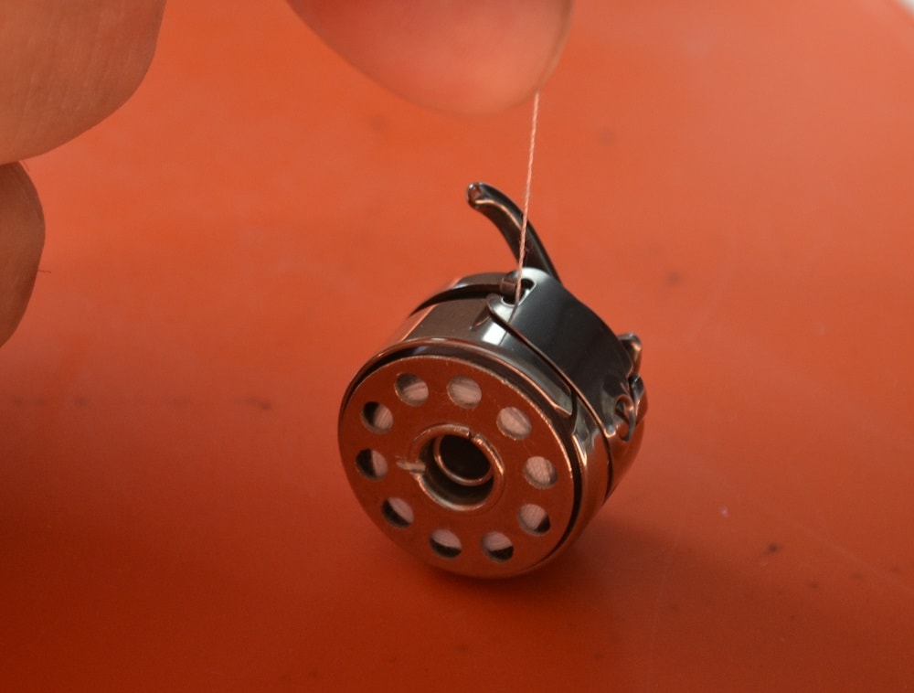 How to adjust a bobbin thread tension