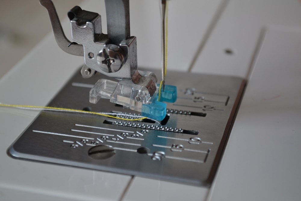 Pull ends of both threads under sole of presser foot