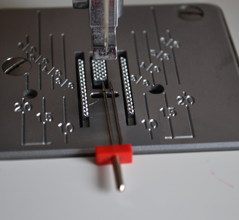 The distance between both needles