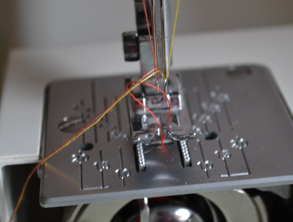 How to pull out thread through a needle plate