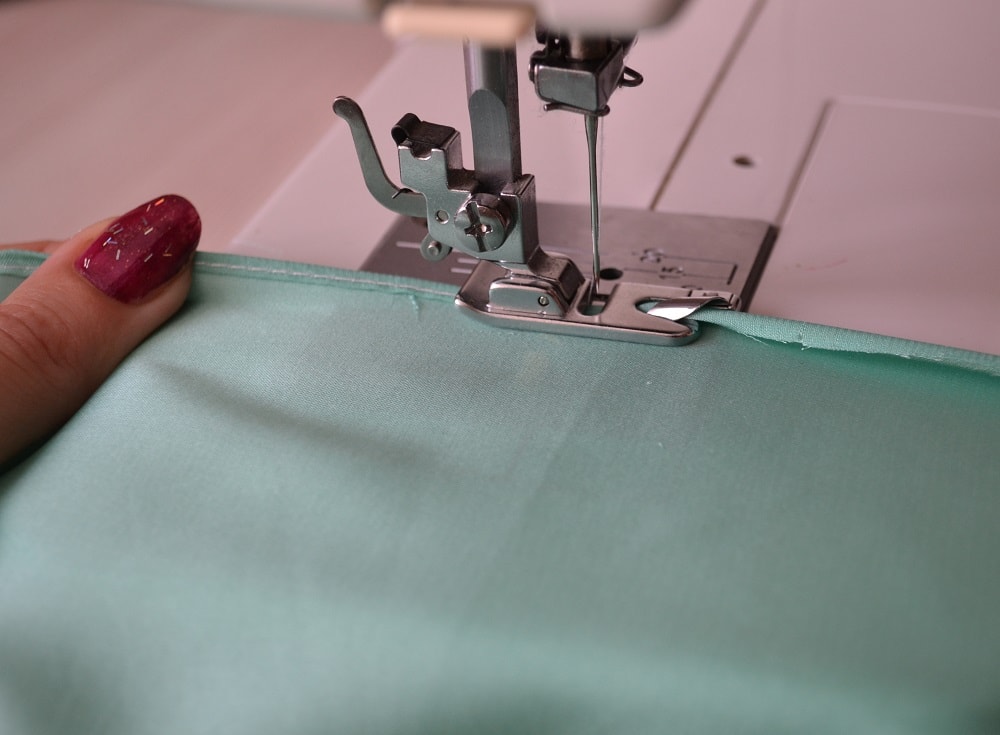 Stretch fabric during hemming