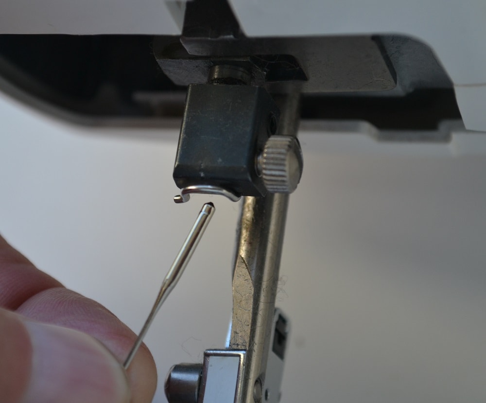 Pull the needle out from the needle bar