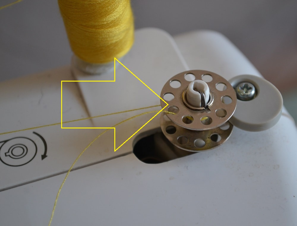 Slide the bobbin to the pin