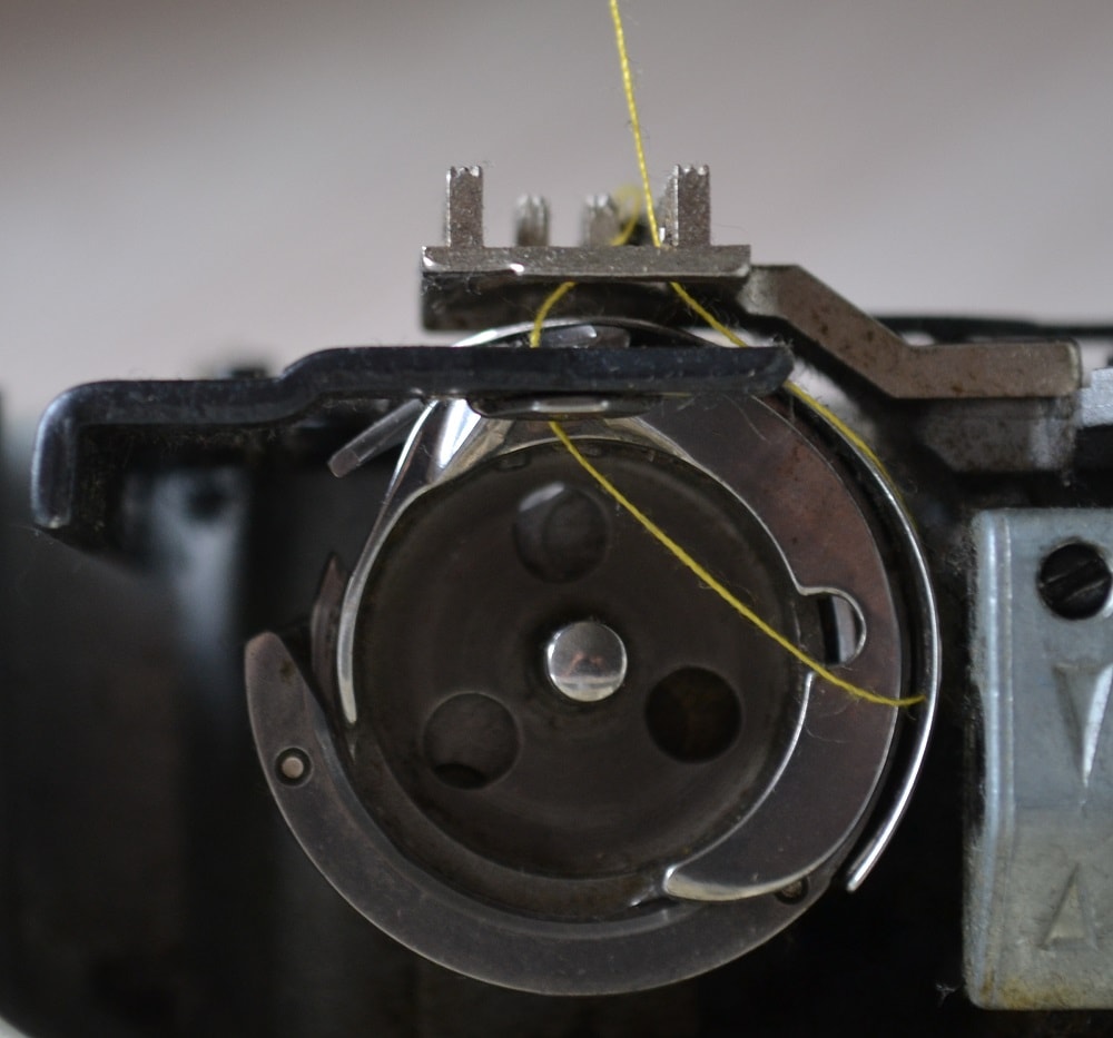 Top needle thread start pull a lower thread
