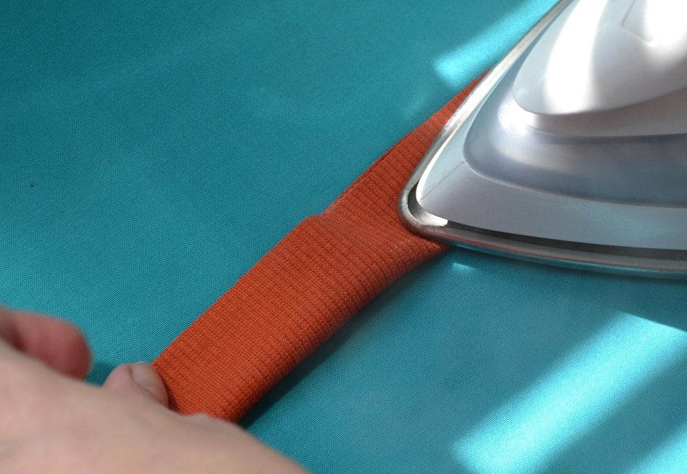 Fold an elastic rib strip in half