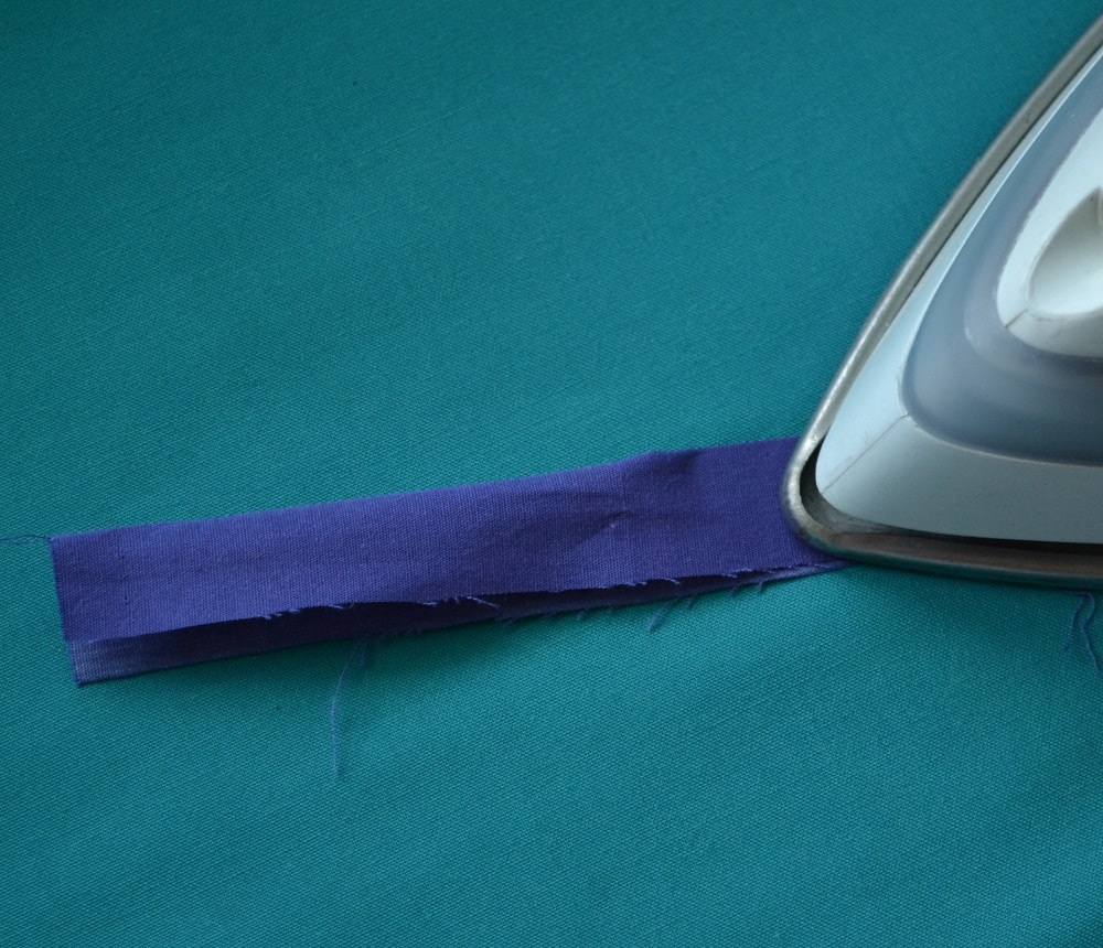 Fold a strip of fabric in half