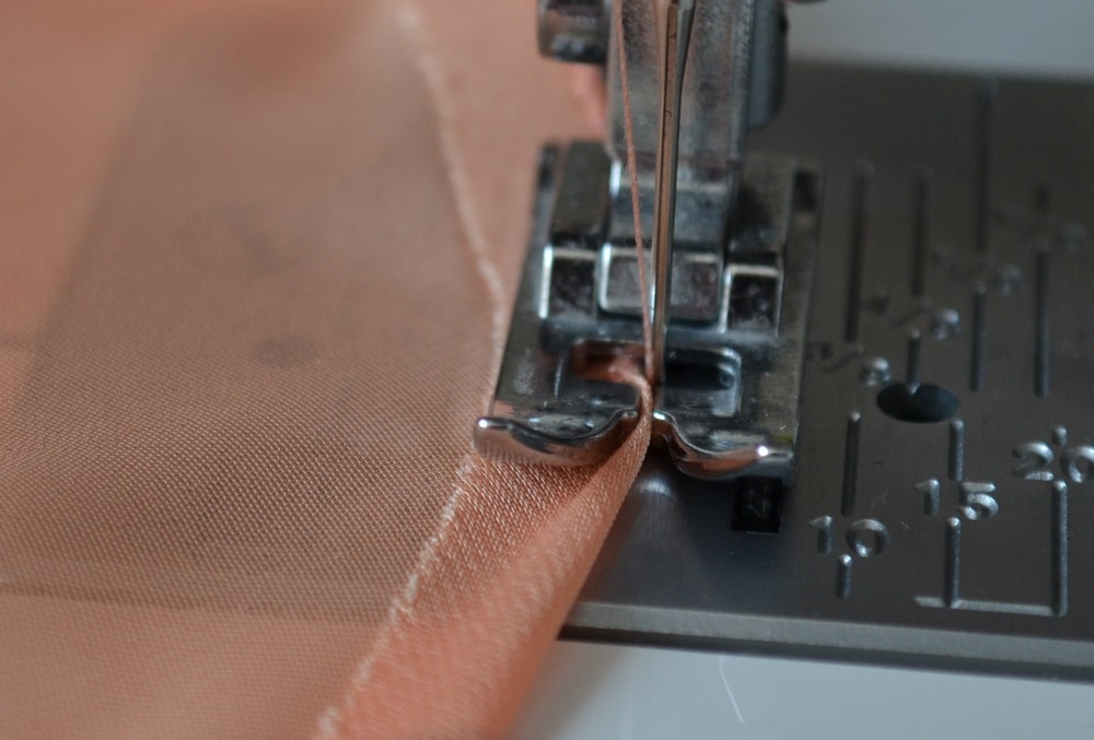 The needle does not pierce the edge of the folded fabric