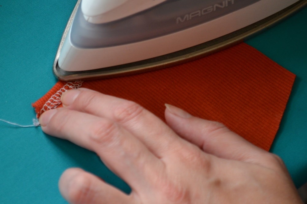 Fold the top edge of pocket to wrong side
