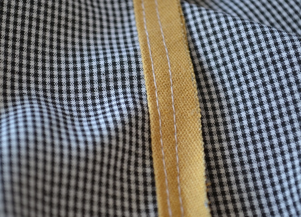 Two stitch lines along edge of pipping