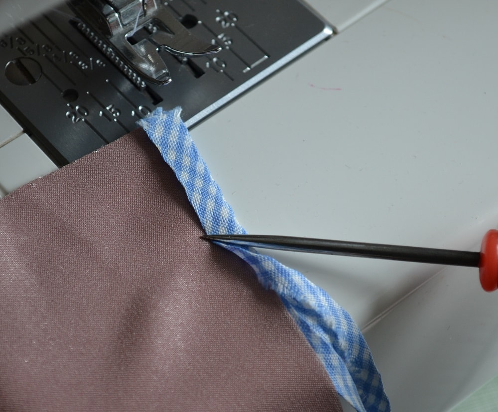Press narrow side of tape to fabric