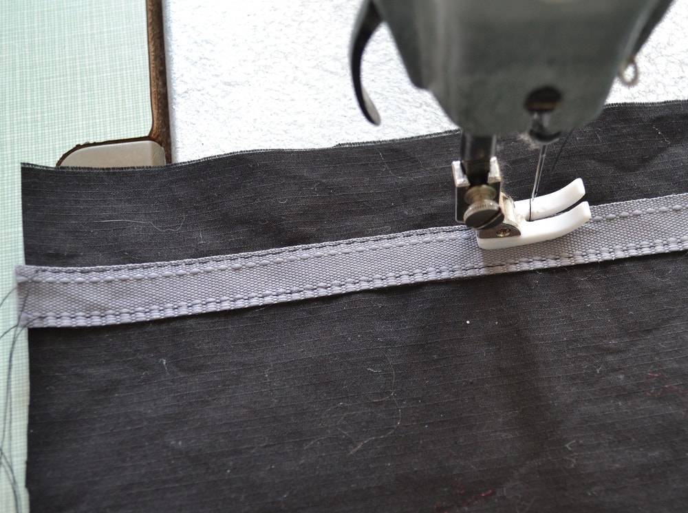 Stitching second edge a tape