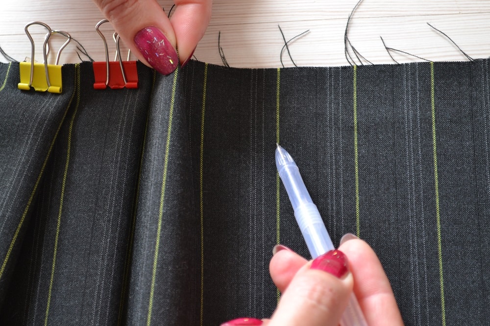 Hand pleating along waistline of skirt