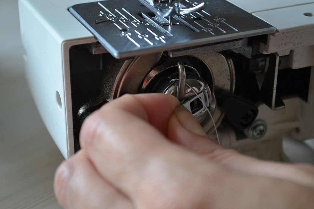 How set bobbin case into shuttle housing