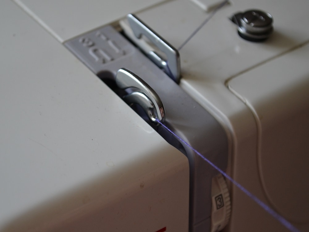 Insert the top thread through this take-up lever