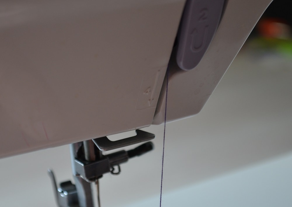 Lower the thread down to the needle
