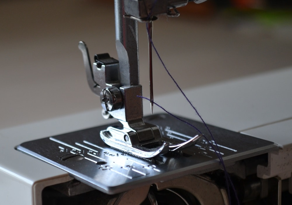Insert the thread end through needle eye