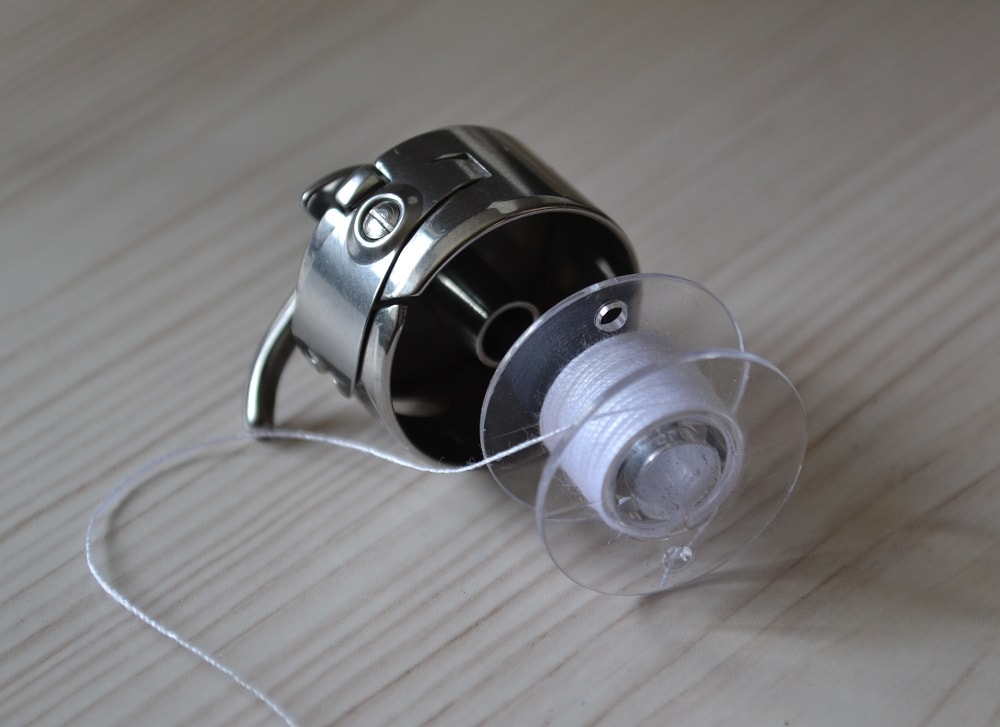 How to insert a spool in bobbin case