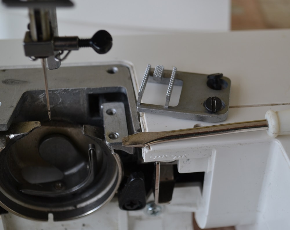 How to unscrew the screws of feed dog