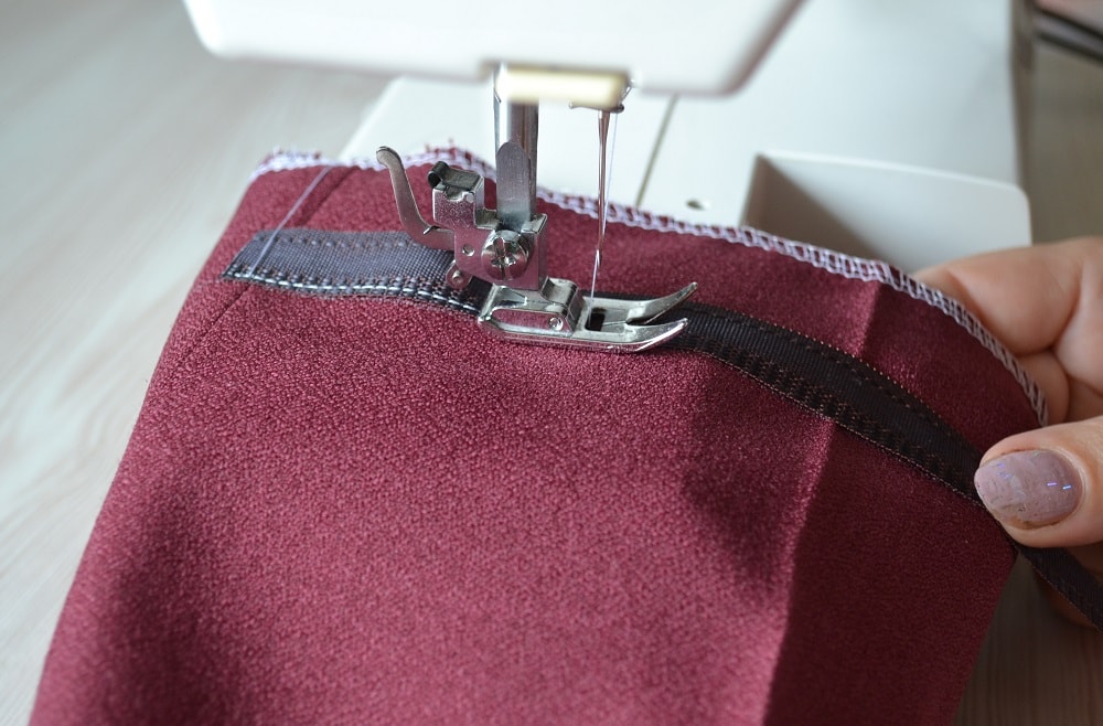 Sewing along the edge of the tape